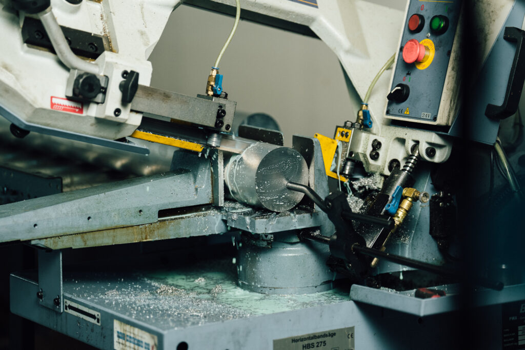 Industrial horizontal band saw in operation at Delta Pump